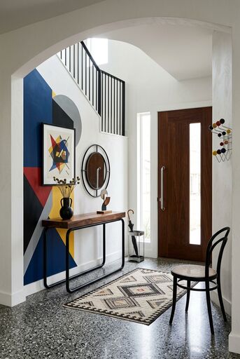 Bauhaus entryway with bold geometry, sculpted forms, and functional storage